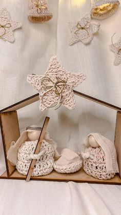 there is a wooden box with crocheted baby booties in it on the table