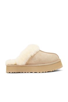 Find UGG Disquette Slipper In Beige on Editorialist. UGG Disquette Slipper in Beige Suede upper with manmade sole. Made in Vietnam Fur Origin: Australia. Slip-on styling. 10mm sheepskin lining and insole. Debossed UGG logo at side. Approx 25mm/ 1 inch platform. UGGF-WZ57. 1122550. About the designer: Uggs Slippers, Animal Fur, Platform Slippers, Fall Shoes, Christmas List, Black Suede, Cute Things, Dress Shoes, Bag Accessories