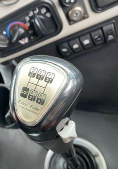 a close up of a car dashboard with buttons and controls