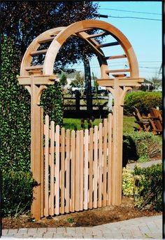 a wooden gate with an arch over it