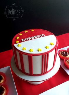 there is a red and white cake with stars on the top that says norberto