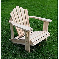 a wooden chair sitting on top of a lush green field