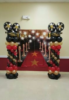 the balloon columns are decorated with black, gold and red balloons