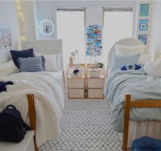 two beds in a room with blue and white decor