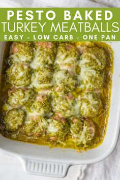 pesto baked turkey meatballs in a white casserole dish with text overlay