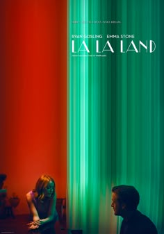 a man and woman sitting next to each other in front of a colorful curtain with the words la la land on it