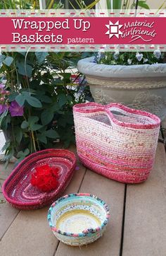 three baskets sitting on top of a wooden table next to flowers and potted plants