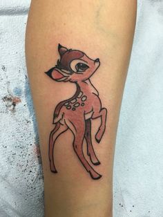 a small deer tattoo on the leg