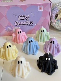 there are many small candles in the shape of ghostes