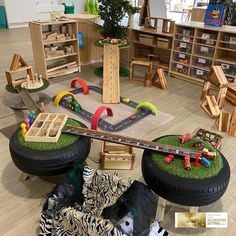 an assortment of toys and furniture in a playroom with zebra print rugs on the floor