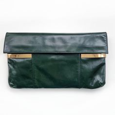 Beautiful vintage envelope clutch in dark green made from genuine, soft leather with gold detail. It has one main compartment lined with beige suede, small pocket, two loops to attach the strap and it fastens with two snap buttons. Perfect, stylish clutch bag for day out or special occasions. Made by Stado. Genuine leather, suede lining. Measures 30 x 17.5 × 2cm. Excellent condition, apart from some tiny leather scratch marks and a small darker shade mark at the back. Please see photo. B. Leather Envelope Bag With Gold-tone Hardware, Green Leather Travel Clutch, Green Leather Clutch For Travel, Vintage Green Clutch For Everyday Use, Green Leather Clutch With Removable Pouch, Green Leather Clutch For Evening, Green Leather Evening Clutch, Chic Green Leather Clutch, Elegant Green Bags With Brass Hardware