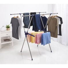 an ironing board with clothes hanging on it