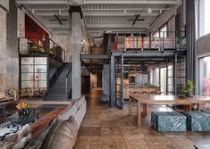 a large open living room with wooden floors and high ceilings is pictured in this image