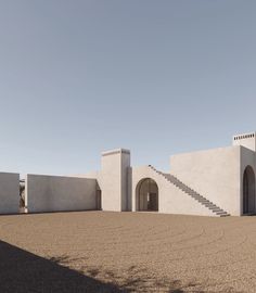 an adobe - style building with stairs leading up to it