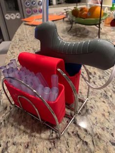 a red basket filled with plastic cups on top of a counter