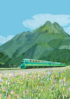 a green train traveling through a lush green field next to a tall mountain covered in flowers