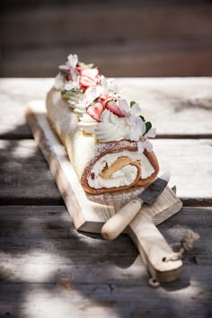 a piece of cake on a wooden board with flowers