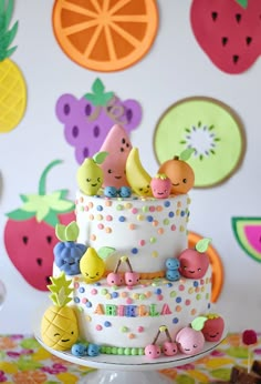 a birthday cake with fruit decorations on it