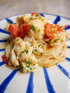 a plate that has some food on it with blue and white stripes around the edge