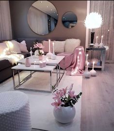 a living room filled with furniture and candles