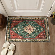 a pair of slippers sitting on top of a wooden floor next to a rug