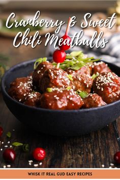 cranberry and sweet chili meatballs in a black bowl on a wooden table