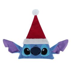 a blue and purple stuffed animal wearing a santa hat