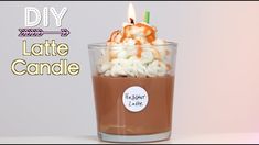 there is a hot chocolate drink with marshmallows in it and a lit candle on top