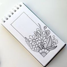 a notebook with a drawing of flowers on it