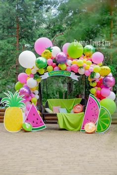 a fruit themed birthday party with balloons, pineapples and watermelon decorations