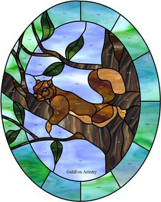 a stained glass window with a squirrel on a tree branch