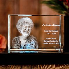 an old woman's glass plaque is displayed on a table