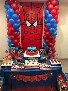 a spiderman themed birthday party with balloons and cake