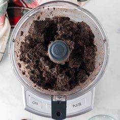 a food processor filled with dirt on top of a counter