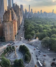 an aerial view of a city with lots of tall buildings and trees in the foreground