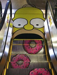 an escalator decorated with cartoon characters and donuts