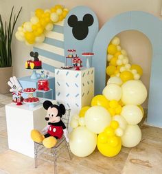 a mickey mouse birthday party with balloons and decorations