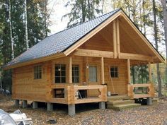 a small wooden cabin in the woods surrounded by trees