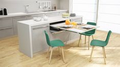 a kitchen with white cabinets and green chairs