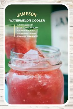 a jar filled with watermelon sitting on top of a wooden table