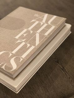 two books sitting on top of a wooden table next to each other with the words art and design printed on them