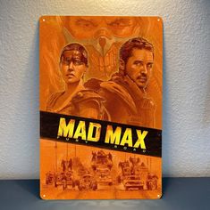 the poster for mad max is displayed on a wall