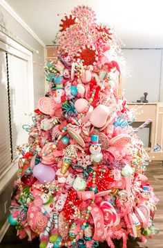 a very colorful christmas tree with lots of candy and candies on it's top