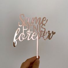 a person holding up a metal cake topper that says summer is forever on it