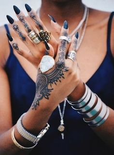 a woman with many rings on her hands