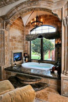 a bathroom with a large tub and stone walls