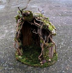 a bird house made out of branches and moss