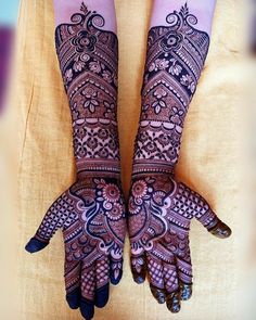 two hands with henna designs on them