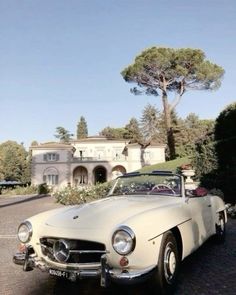 an old car parked in front of a house