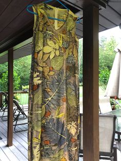 a dress is hanging on a wooden porch